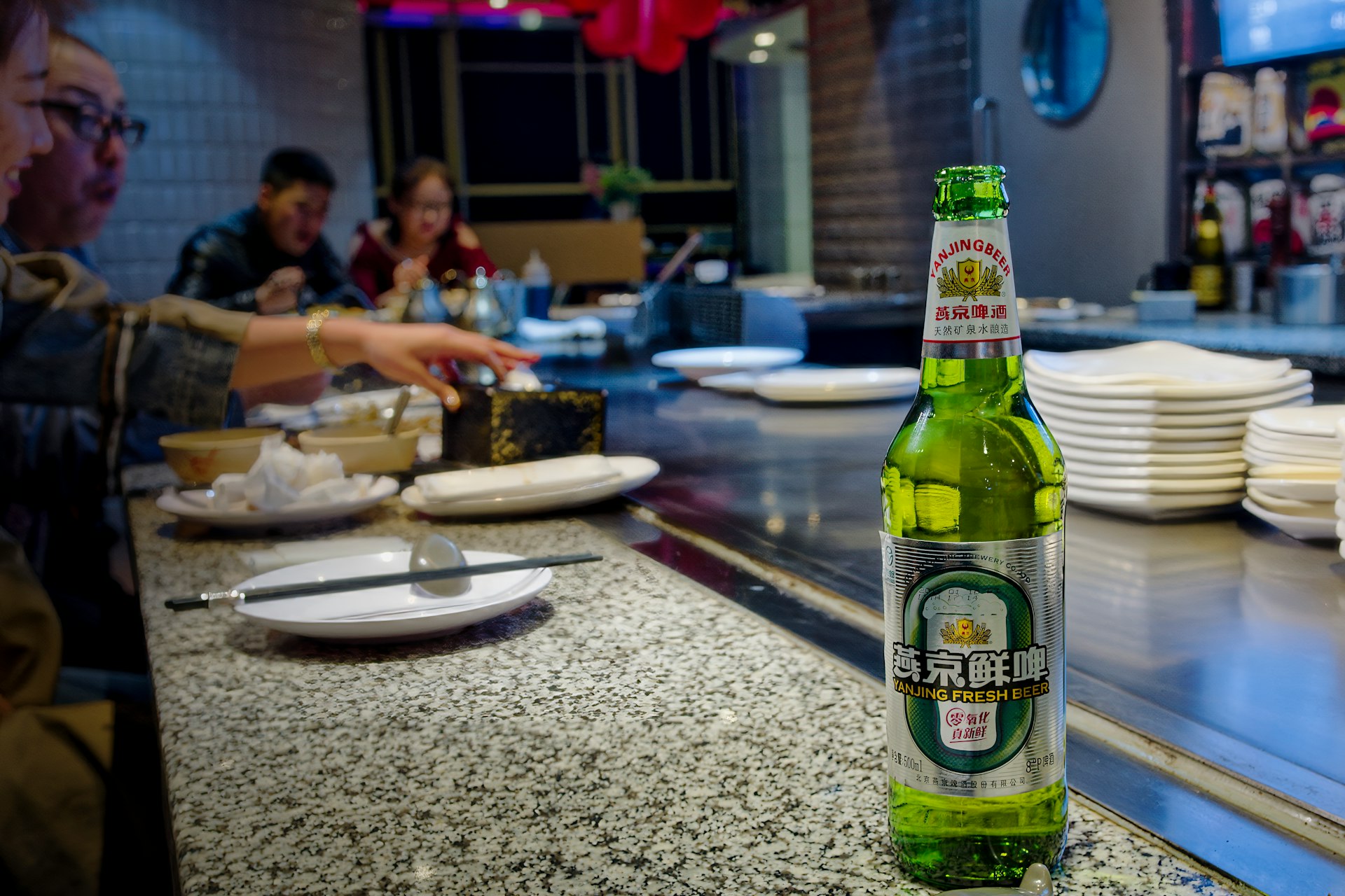 A bottle of beer sitting on top of a counter