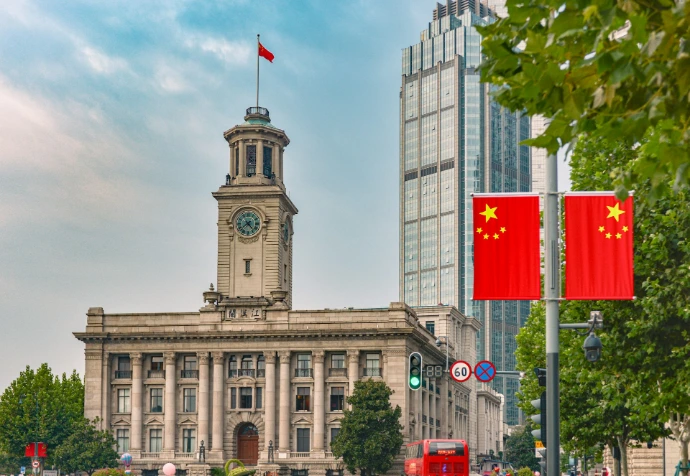 a large building with a clock tower in the middle of a city